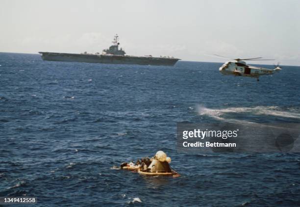 The USS Ticonderoga, prime recovery vessel, and a helicopter provide the background for Apollo 16 recovery activities in the Pacific Ocean 2,278...