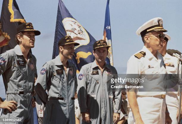 Captain Edward A Boyd, commanding officer of the USS Ticonderoga, prime recovery vessel, greets astronauts Charles M Duke Jr, Thomas K Mattingly II,...