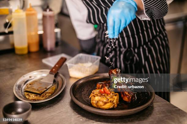 chef serving marinated ribs and potatoes - meat dish stock pictures, royalty-free photos & images