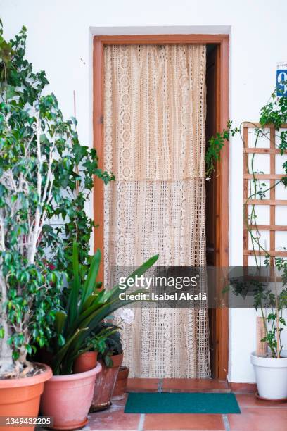 an entrance wooden frame door covered with a lace curtain - altea spain stock pictures, royalty-free photos & images