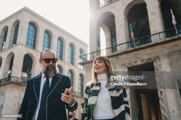 business people are walking in the city - piazza del duomo, milan - milan financial district stock pictures, royalty-free photos & images