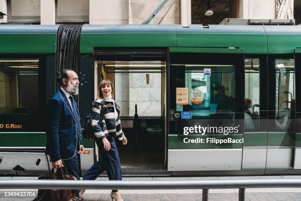 business people are commuting to the office by tram - milan italy stockfoto's en -beelden