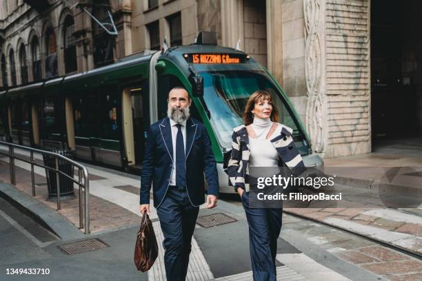 business people are commuting to the office by tram - milan business stock pictures, royalty-free photos & images