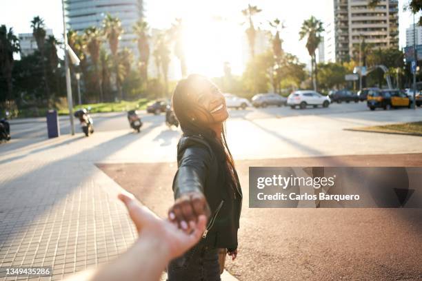 point of view of girlfriend holding hands of boyfriend while on vacations being happy and leading to the city. - barcelona free stock-fotos und bilder