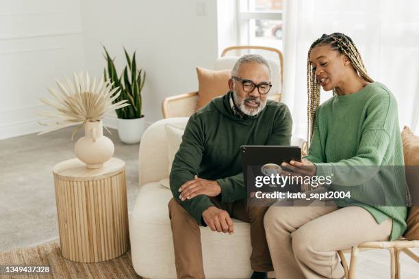 helping with tax planning - afro-caribbean ethnicity stock pictures, royalty-free photos & images