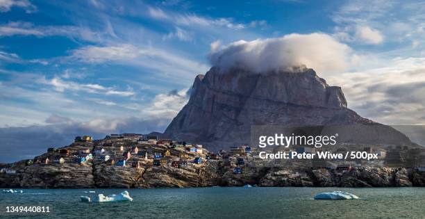 panoramic view of sea and buildings against sky,uummannaq,greenland - greenland uummannaq stock pictures, royalty-free photos & images
