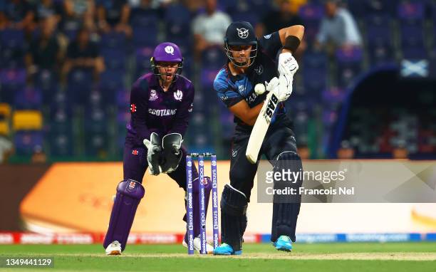 Smit of Namibia plays a shot as Matthew Cross of Scotland looks on during the ICC Men's T20 World Cup match between Scotland and Namibia at Sheikh...