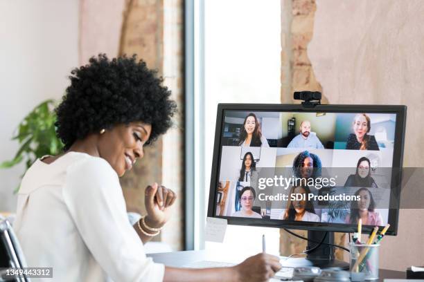 attending class virtually, mid adult woman takes notes - focus group stock pictures, royalty-free photos & images