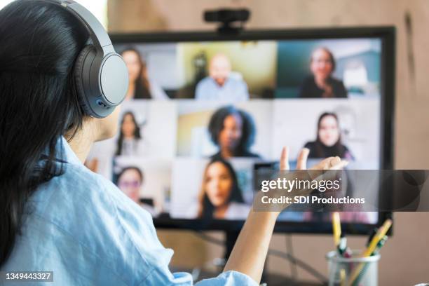 rear view woman leading virtual meeting with multi-ethnic group - employee engagement virtual stock pictures, royalty-free photos & images