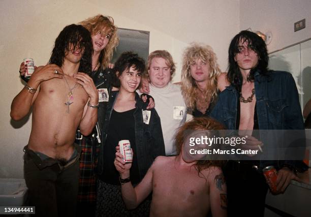 Slash, Duff McKagan, Teresa Ensenat , Tom Zutaut , Axl Rose , Steven Adler and Izzy Stradlin of the rock group 'Guns n' Roses' backstage at the Santa...