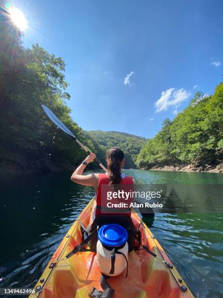 young girl enjoying a day of kayaking through an imposing and colorful natural landscape - madrid travel stock pictures, royalty-free photos & images