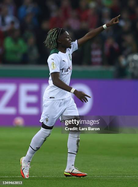 Kouadio Kone of Borussia Moenchengladbach celebrates after scoring their team's first goal during the DFB Cup second round match between Borussia...