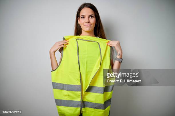 woman holding safety vest on white background - waistcoat 個照片及圖片檔