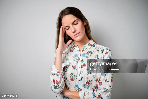 portrait of woman with headache on white background - 26 years old stock pictures, royalty-free photos & images