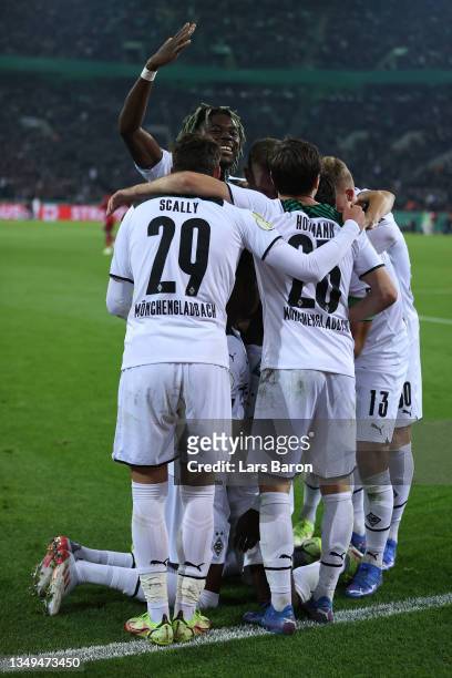 Breel Embolo celebrates with teammates Joe Scally, Jonas Hofmann and Lars Stindl of Borussia Moenchengladbach after scoring their team's fourth goal...