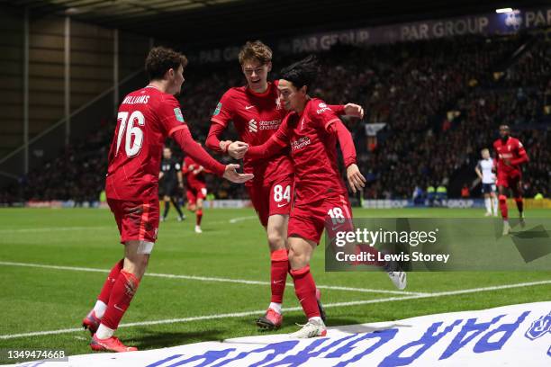 Takumi Minamino celebrates with teammates Conor Bradley and Neco Williams of Liverpool after scoring their team's first goal during the Carabao Cup...