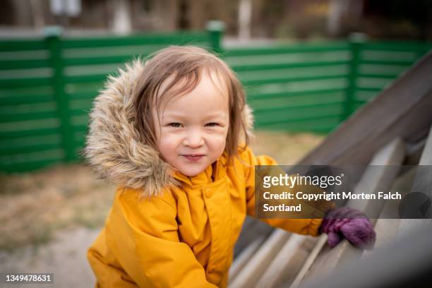 a child cheerfully climbing up a ladder - oslo play stock pictures, royalty-free photos & images