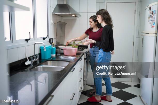 lesbian couple cooking together. - cute lesbian couples stockfoto's en -beelden