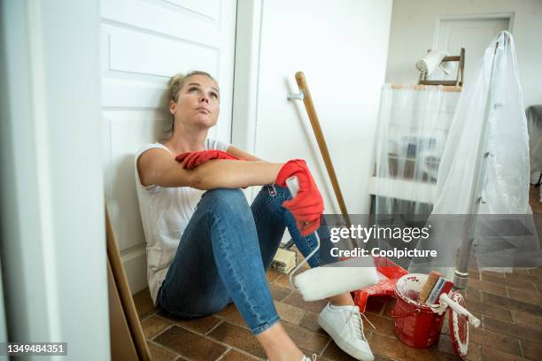 young woman moving in a new house - painting. - step stool stock pictures, royalty-free photos & images