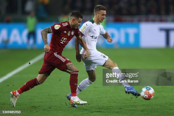 Lucas Hernandez of FC Bayern Muenchen battles for possession with Patrick Herrmann of Borussia Moenchengladbach during the DFB Cup second round match...