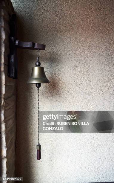 close-up of brass bell hanging on brick wall - brick wall brass stock pictures, royalty-free photos & images