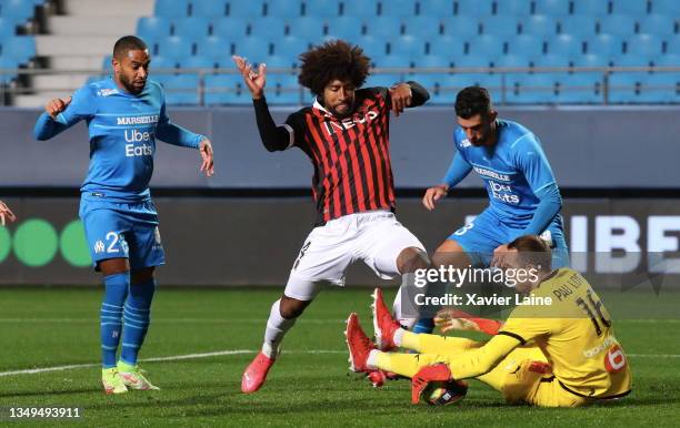 Dante Costa Santos of Nice in action over Alvaro Gonzales and Pau Lopez of Marseille during the Ligue 1 Uber Eats match between Nice and Marseille at...