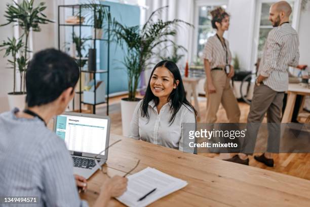 female candidate giving interview with hr manager at office - candidate experience stock pictures, royalty-free photos & images