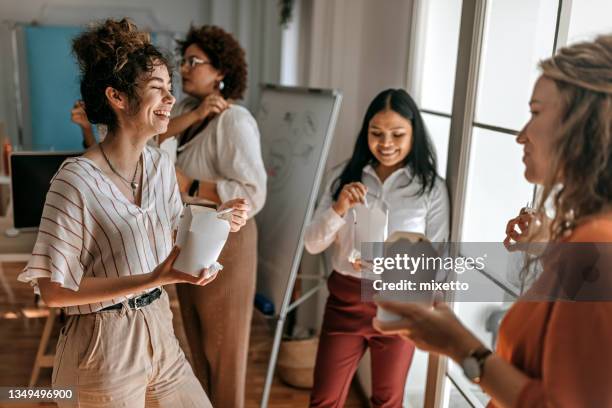 business colleagues having fun during lunch break at office - asian young executive laughing office bildbanksfoton och bilder