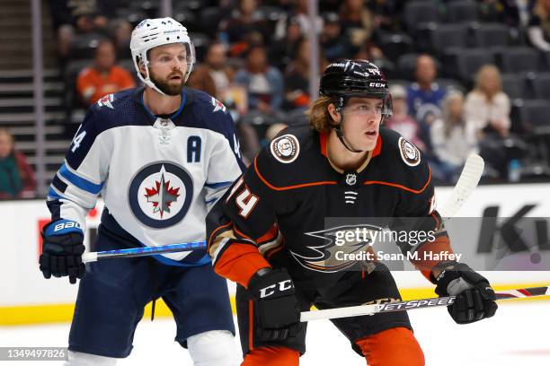 Max Comtois of the Anaheim Ducks looks for a pass as Josh Morrissey of the Winnipeg Jets defends during the third period of a game at Honda Center on...