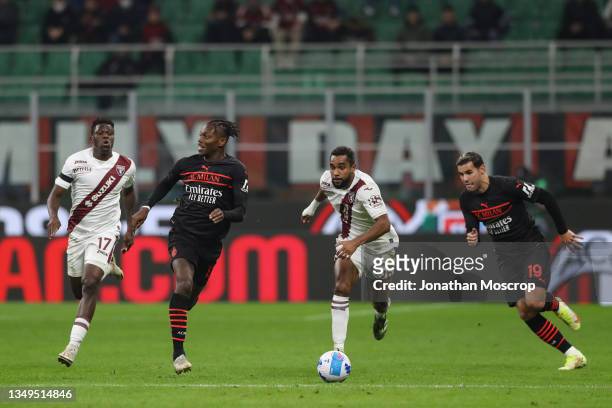 Rafael Leao of AC Milan races after the ball as he is pursued by Wilfried Singo and Djidji Koffi of Torino FC and team mate Theo Hernandez during the...