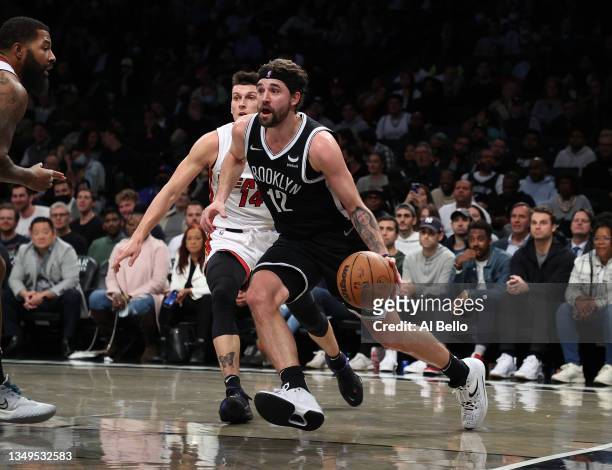 Joe Harris of the Brooklyn Nets drives against the Miami Heat during their game at Barclays Center on October 27, 2021 in New York City. NOTE TO...