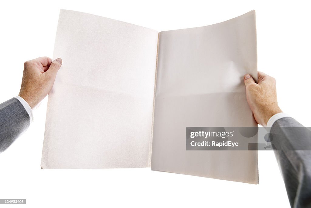 Man's hands clutch blank, open newspaper tightly.