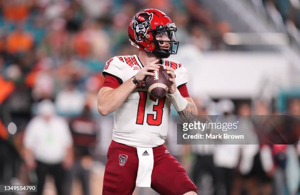 Devin Leary of the North Carolina State Wolfpack looks to pass against the Miami Hurricanes at Hard Rock Stadium on October 23, 2021 in Miami...