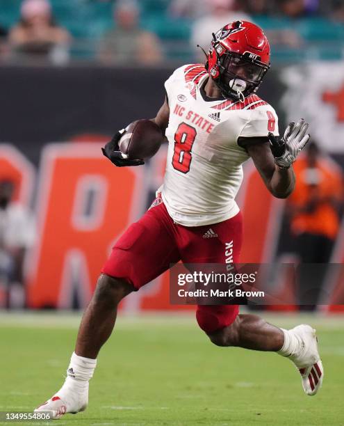 Ricky Person Jr. #8 of the North Carolina State Wolfpack in action against the Miami Hurricanes at Hard Rock Stadium on October 23, 2021 in Miami...