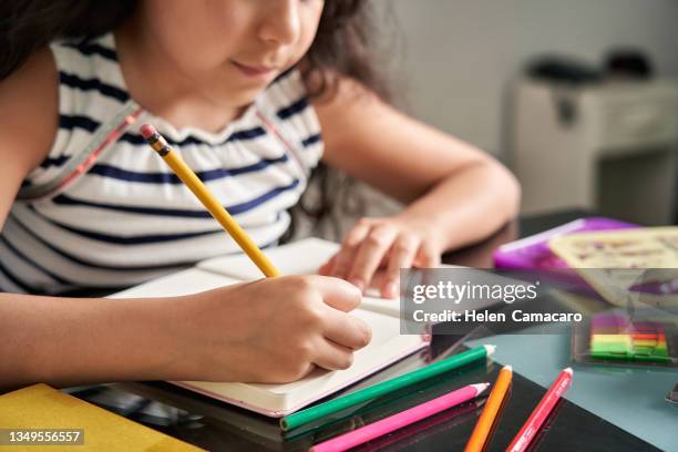 close up of little girl doing homework at home - venezuelan girls stock pictures, royalty-free photos & images