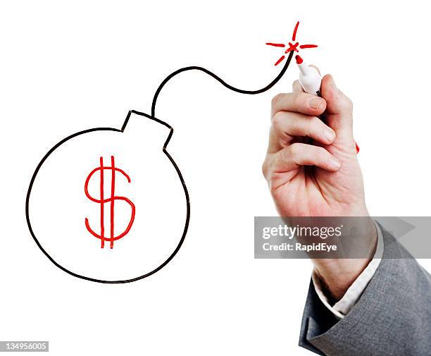 businessman's hand draws bomb containing dollar sign on whiteboard - explosive fuse stock pictures, royalty-free photos & images