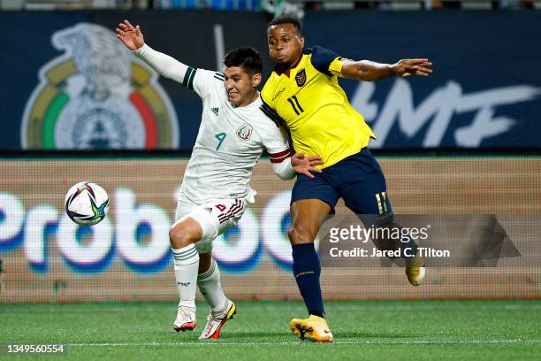 Michael Estrada of Ecuador and Jesus Alberto Angulo of Mexico battle for possession during the first half of their match at Bank of America Stadium...