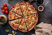 Sausage and vegetable pizza on dark background