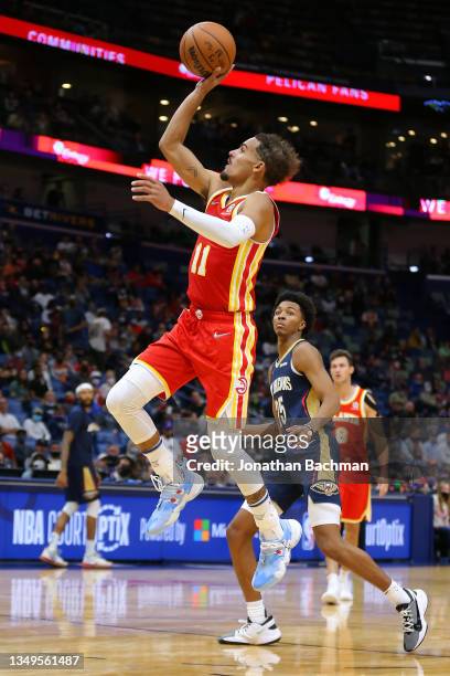 Trae Young of the Atlanta Hawks shoots as Trey Murphy III of the New Orleans Pelicans defends during the second half at the Smoothie King Center on...