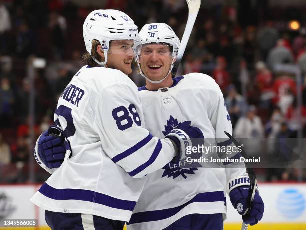 William Nylander of the Toronto Maple Leafs celebrates getting the game-winning goal in overtime against the Chicago Blackhawks with teammate Rasmus...