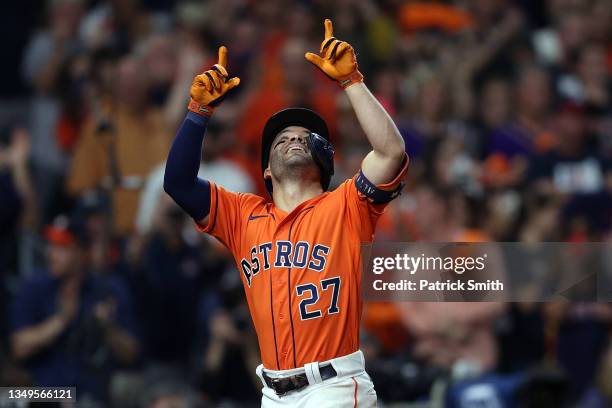 Jose Altuve of the Houston Astros celebrates after hitting a one run home run against the Atlanta Braves during the seventh inning in Game Two of the...