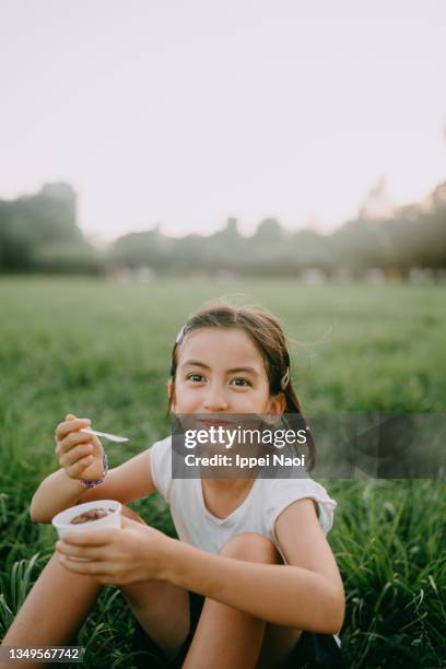 cheerful young girl enjoying ice cream in park, tokyo - picknick kid stock pictures, royalty-free photos & images