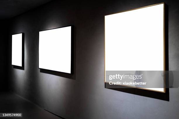 three picture frames on black concrete wall - exposition wall ストックフォトと画像