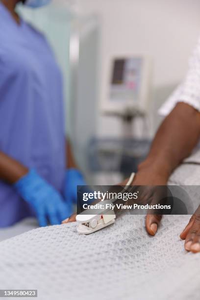 close up of hospitalized patient's hand with pulse oximeter - pulse oximeter stock pictures, royalty-free photos & images