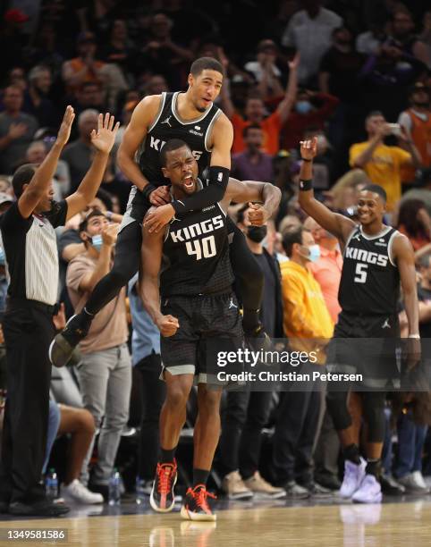 Harrison Barnes of the Sacramento Kings celebrates with Tyrese Haliburton and De'Aaron Fox after Barnes hit the game-winning three-point shot against...