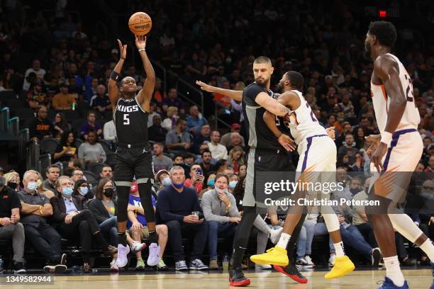 De'Aaron Fox of the Sacramento Kings attempts a three-point shot against the Phoenix Suns during the first half of the NBA game at Footprint Center...