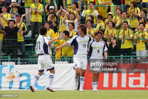 Takenori Hayashi of JEF United Chiba celebrates scoring his side's fifth goal with his team mates Seiichiro Maki and Masataka Sakamoto during the...