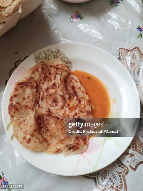 roti canai, roti pratha with dhal curry - roti canai stock pictures, royalty-free photos & images
