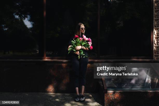 beautiful blonde girl with a bouquet of peonies. - new pink background stock pictures, royalty-free photos & images