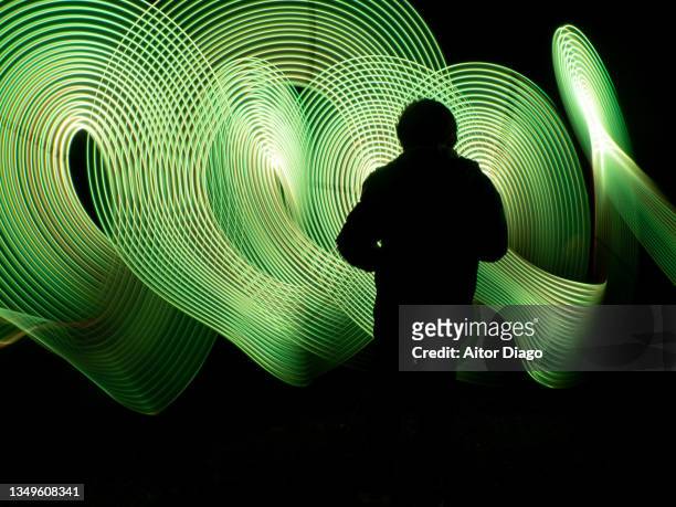 silhouette of a child in a futuristic, virtual robotic environment. 3d. light painting - children only stock-fotos und bilder
